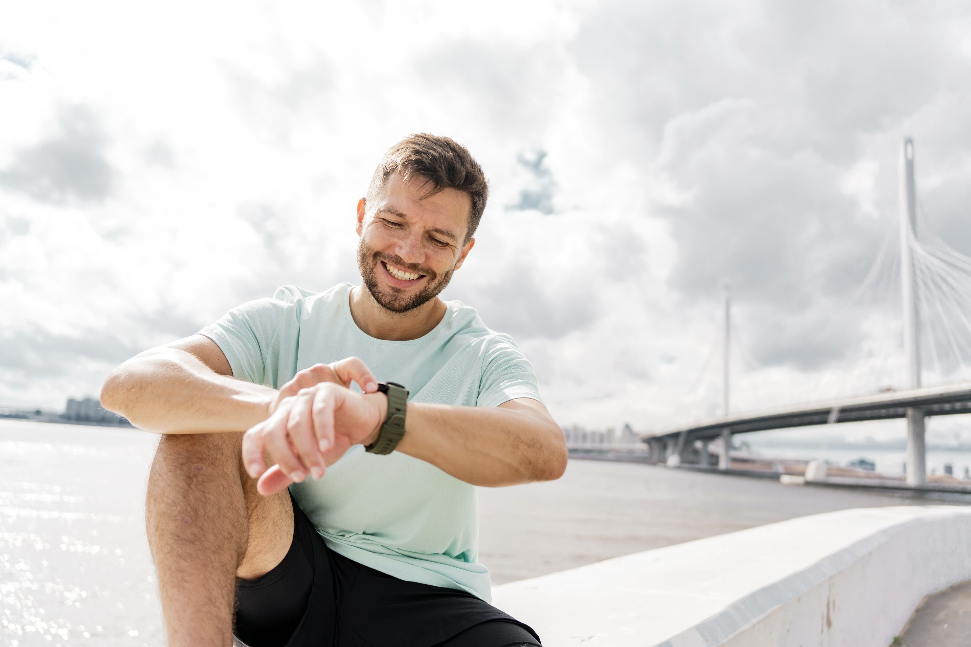 Man checking his Apple Watch during a workout for fitness and heart data