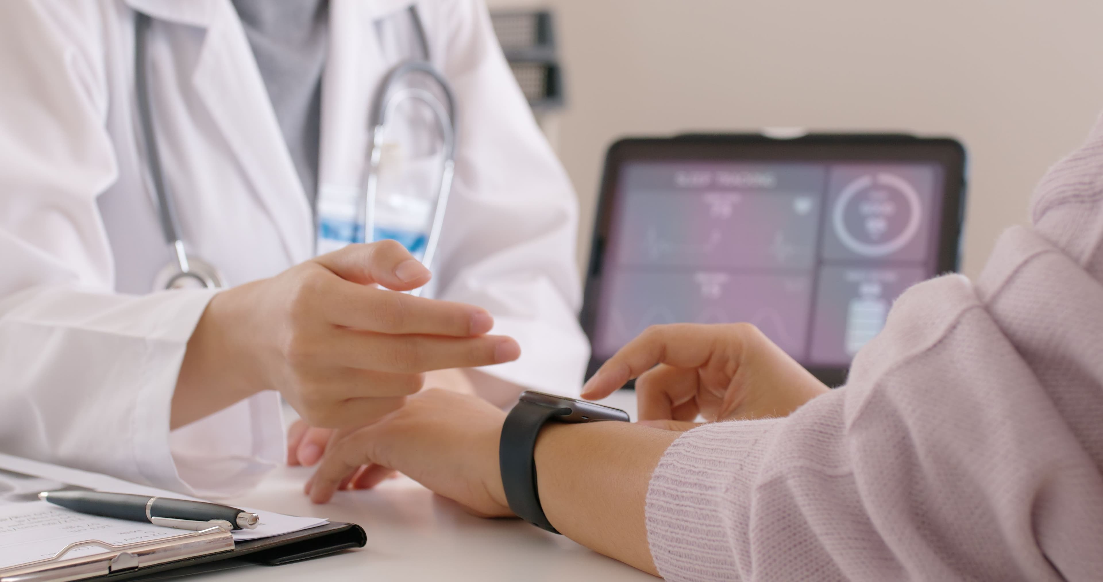 Doctor checking a patient vitals with a wearable device